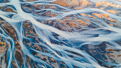 A glacial rivers from above. Aerial photograph of the river streams from Icelandic glaciers. Beautiful art of the Mother nature created in Iceland. Wallpaper background high quality photo - 373761470
