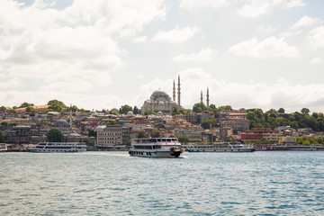 Naklejka premium Panoramic shot of the old town Istanbul; The Hagia Sophia (Ayasofya) Mosque Eminonu, ferries and boats on the Golden Horn, Istanbul, Turkey.