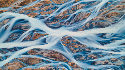 A glacial rivers from above. Aerial photograph of the river streams from Icelandic glaciers. Beautiful art of the Mother nature created in Iceland. Wallpaper background high quality photo - 373762093
