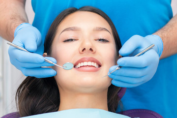dentist examines the patients teeth at the dentist.
