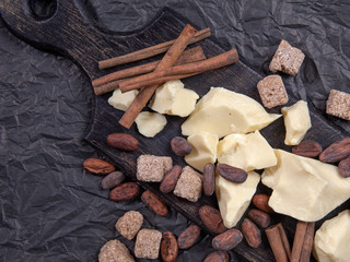 Pieces of natural cocoa butter with cinnamon, cocoa beans and cane sugar