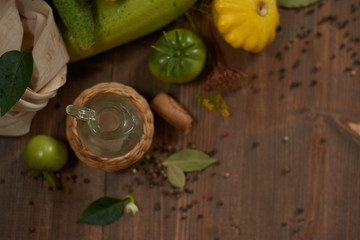
Fresh vegetables, peppercorns and a small glass jar on a wooden background flat lay.