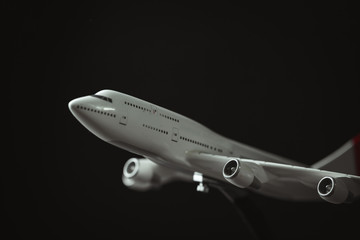 white airplane model on the black background. macro shot of aircraft with copy space