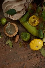 
Fresh vegetables, peppercorns and a small glass jar on a wooden background flat lay.