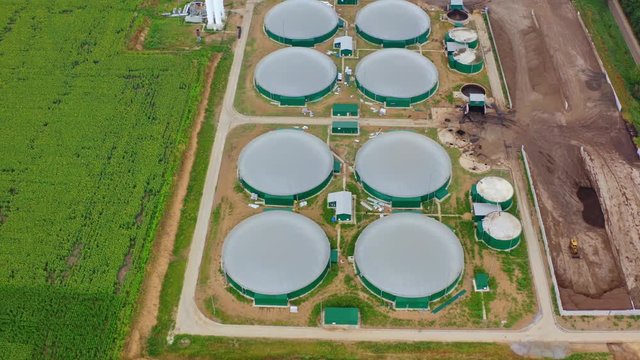 Production of sustainable fuel called bio gas. New factory in field. Video from above. Ecological production.