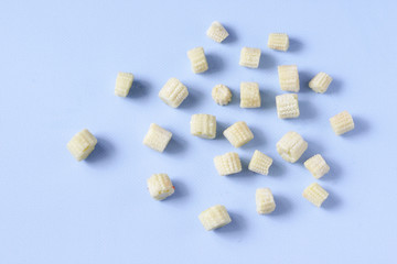 Frozen vegetables baby corn on a blue background with copy space. Top view. Horizontal orientation