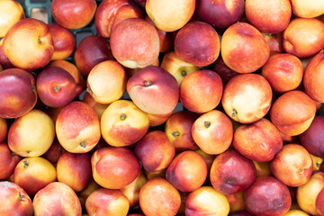 background of red peachs on sale at the local market