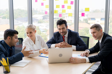 Group of business people are working together and discussing about the project in the meeting room at the office. Full concentration in the meeting when presenting with smiling face