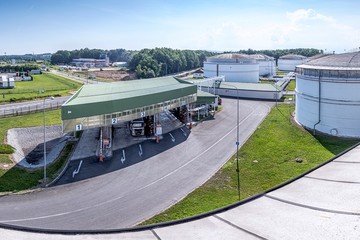 Petrochemical fuel base with loading islands and truck and tanks on the background, Czech Republic