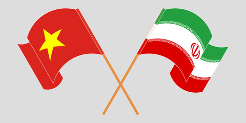 Crossed and waving flags of Iran and Vietnam