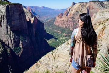 young woman overlooking a canyon in Zion National Park