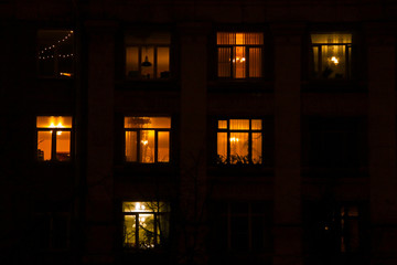Glowing apartments windows at night where each occupant has his own privacy © Sergey