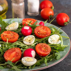 Diet salad with radish, tomatoes, quail eggs and ruccola. Healthy  food concept.