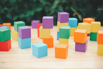 stack of colorful wood cube building blocks