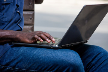close-up of a young man with laptop.
