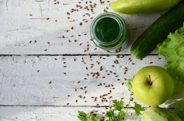 Detox diet. Green smoothie with different vegetables on white wooden background copy space. diet vegitarians healthy low calorie food. salad, greens, green apple chia or flax linen seeds