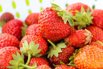 Background from freshly harvested strawberries, directly above. Summer photo with beautiful and juicy strawberries. Fresh organic berries macro. Red ripe. Close up, isolated. 