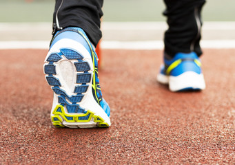 Children's hands fasten sports shoes