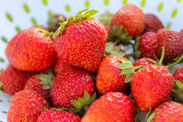 Background from freshly harvested strawberries, directly above. Summer photo with beautiful and juicy strawberries. Fresh organic berries macro. Red ripe. Close up, isolated. 