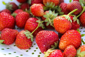 Background from freshly harvested strawberries, directly above. Summer photo with beautiful and juicy strawberries. Fresh organic berries macro. Red ripe. Close up, isolated. 