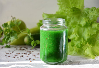 Detox diet. Green smoothie with different vegetables on white wooden background copy space. diet vegitarians healthy low calorie food. salad, greens, green apple chia or flax linen seeds