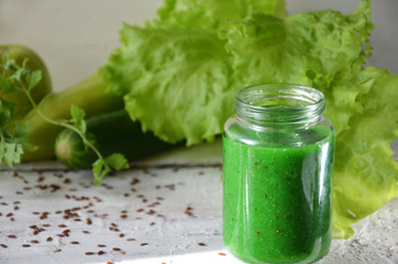 Detox diet. Green smoothie with different vegetables on white wooden background copy space. diet vegitarians healthy low calorie food. salad, greens, green apple chia or flax linen seeds