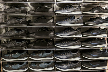 Multi-storey shelves with rows of man sport shoes
