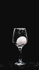 fresh water splashing, while a lemon falling in to a wine glass.