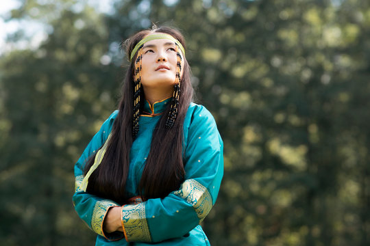 Mongolian woman wearing typical Mongolian cyan dress.