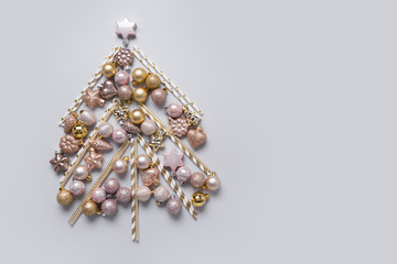 Christmas tree made of silver, golden balls, stars. Xmas greeting card with copy space.