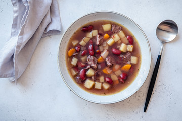 Bean soup with potato and carrot in bowl