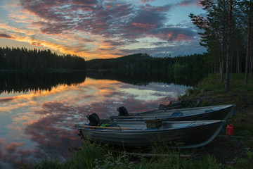 Fototapeta na wymiar White nights over the calm nordic forest lake