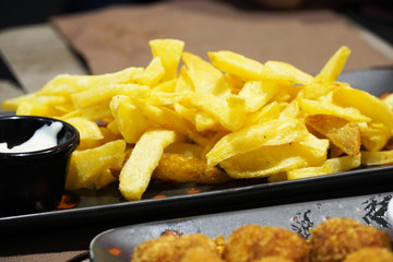 French fries in olive oil on dining table.