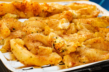 Chicken meat grilling on gas grill