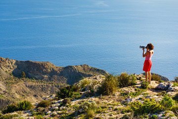 Woman with camera take travel photo