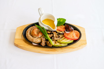 Home-made sausage with grilled vegetables and sweet mustard. Pretty homemade meal. Cooking and baking food while quarantining  at home during the coronavirus pandemic.