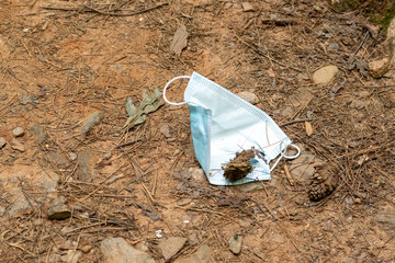 Face mask discarded on mountain trail