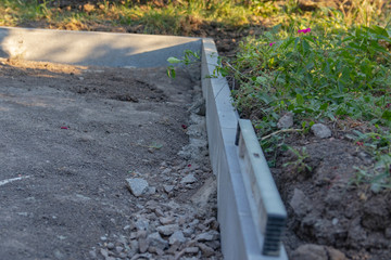 Installation of curbs. laying curb stones using concrete. Selective focus.