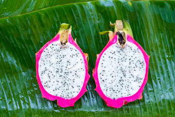 Ripe dragon fruit on a wet green leaf. Vitamins, fruits, healthy foods