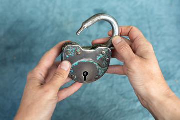 Open old iron lock in women's hands. The concept of liberation from male violence, the end of...