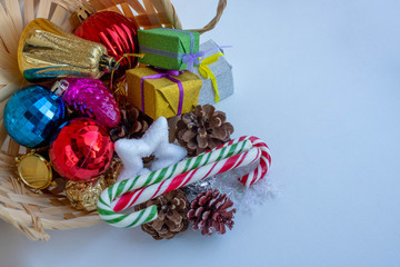 Christmas basket with Christmas toys on a white background. Space for text