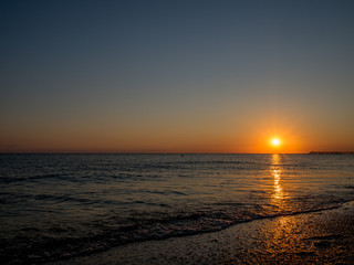 The sun sets in the sea. Bright sea sunset on the South coast.