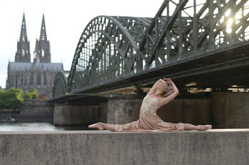 A beautiful ballet dancer ballerina outdoors ,Ballerina dancing on the bridge  in Cologne City .