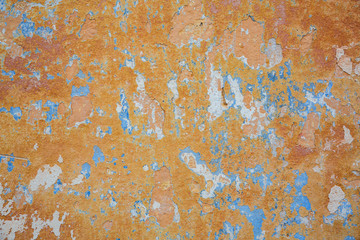 Texture of old wall with shabby orange and blue paint. Background