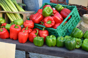 Red and green paprika, leeks at the farmers market.