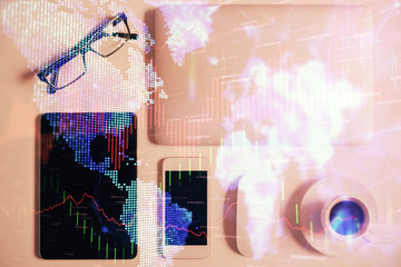 Multi exposure of financial chart hologram over desktop with phone. Top view. Mobile trade platform concept.