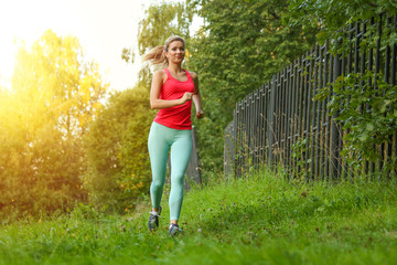 running young woman outdoor in summer. female jogging at sunset