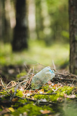 Plastic bottle rubbish left in the forest or park 