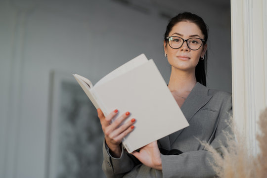 Young Woman Reading A Newspaper