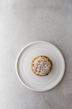 Above view of  an isolate Paris Brest french pastry cake confectioner on a ceramic plate